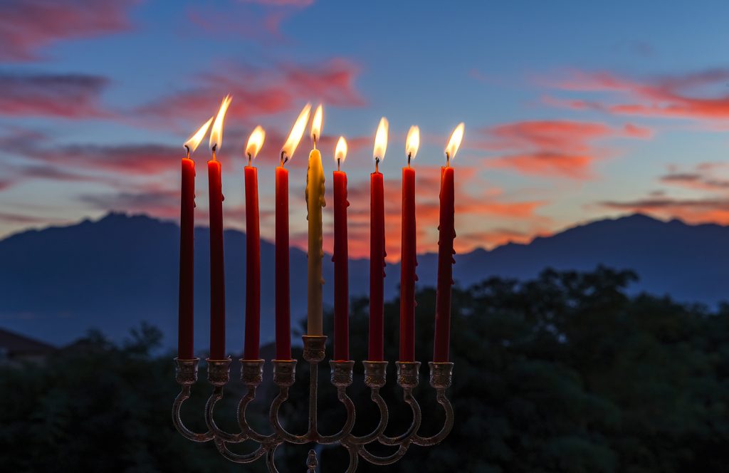 Glitter lights of candles on menorah are traditional symbols for mundo